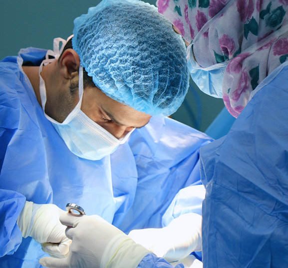 Two surgeons in blue scrubs and masks focus intently on a procedure. The atmosphere is calm and professional, highlighting the surgical environment.