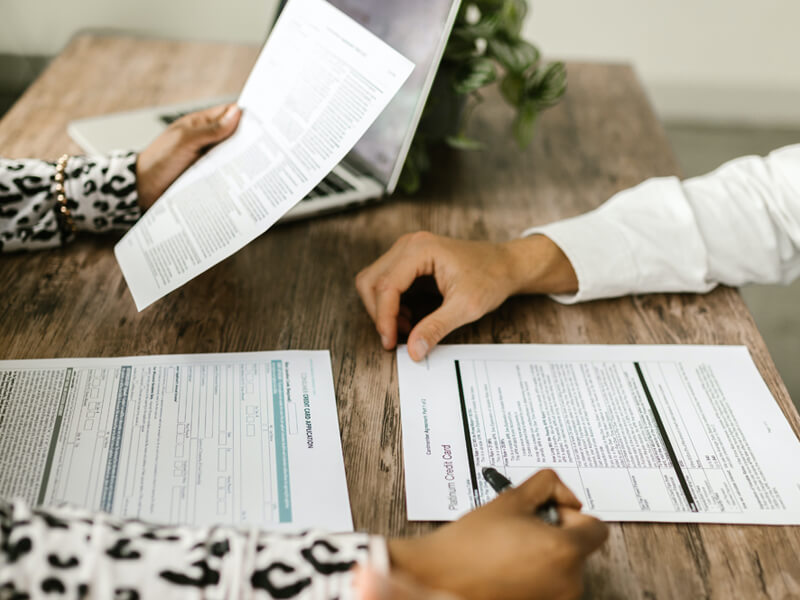 Two people reviewing documents at table.